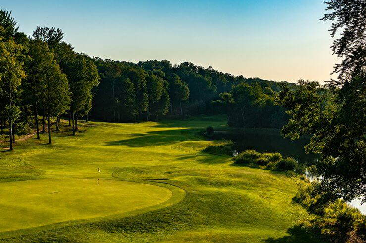 The sun rising on a beautiful golf course